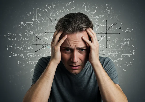 Person experiencing math anxiety with chaotic symbols